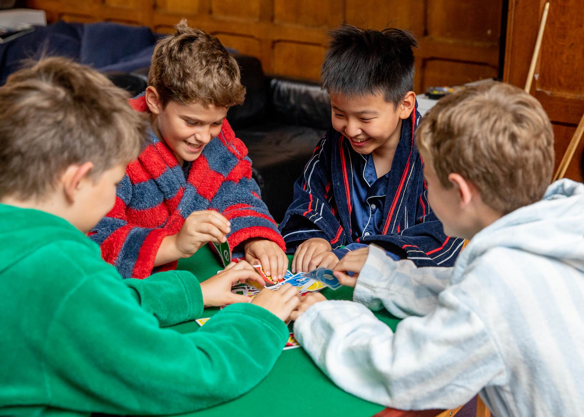 Middle boys boarders playing cards